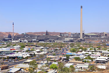 The Mount Isa Mine dominates the town of Mt Isa on a very hot summer day. Elevated view from lookout. Horizontal, copy space.